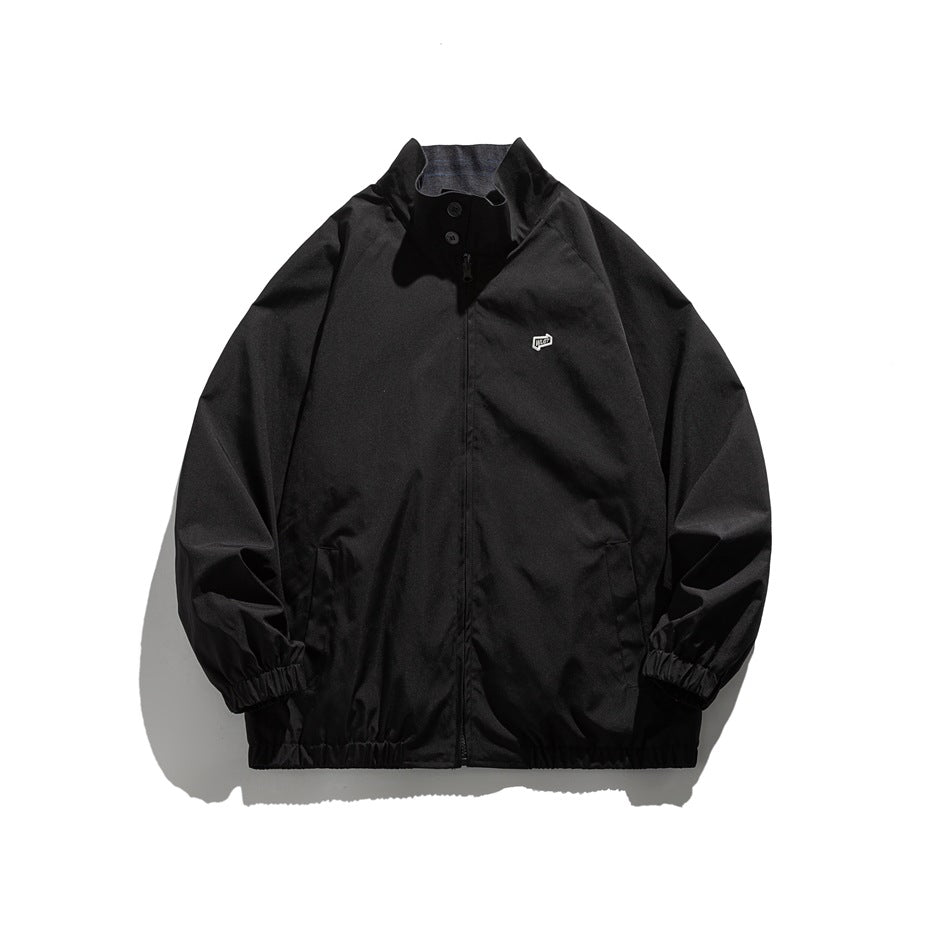 Black zip-up Harrington jacket with stand collar, snap buttons, elastic cuffs and hem, laid flat