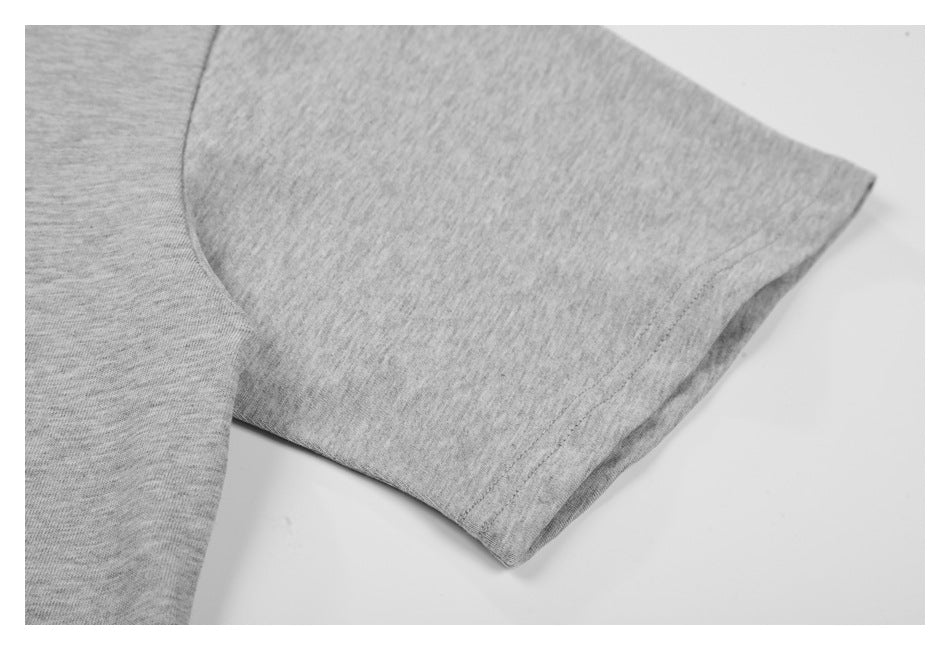 Close-up of the heather gray T-shirt's short sleeve and stitched sleeve hem.