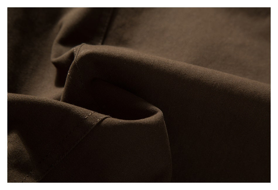 Close-up of folded brown garment fabric and a stitched edge.