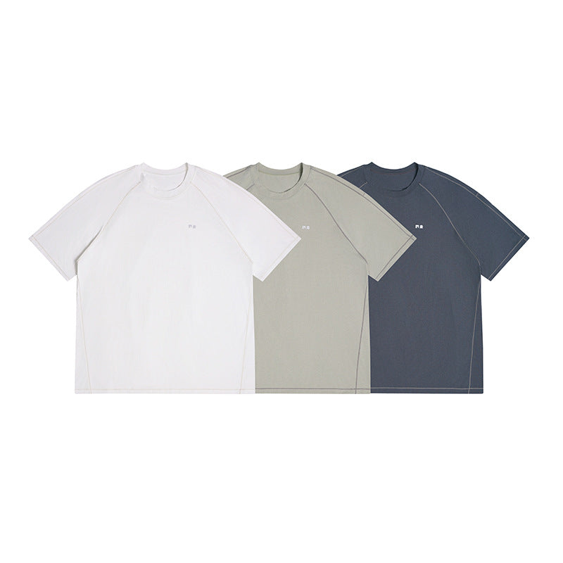 Three short-sleeve crew-neck shirts shown together in white, light gray-green, and dark slate.