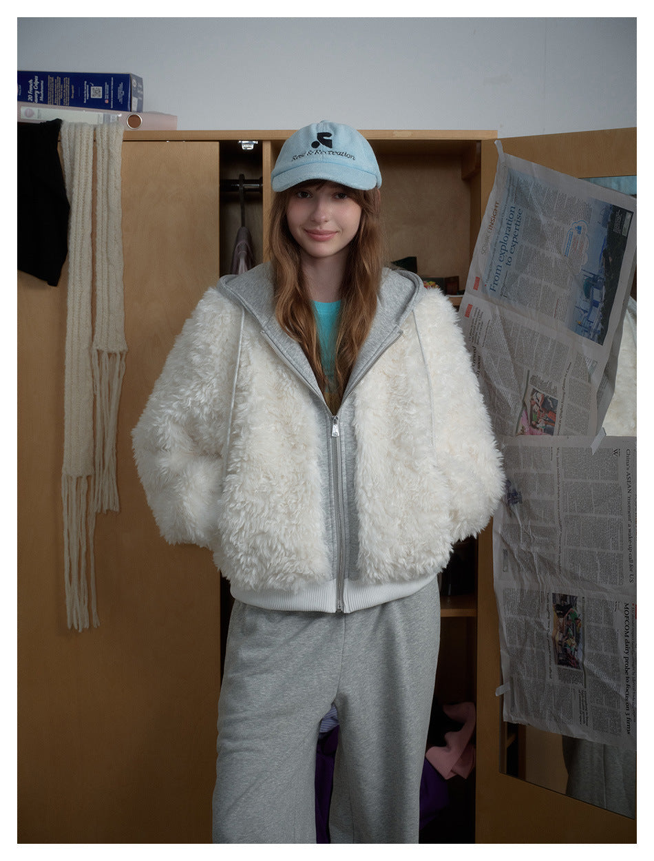 Front view of a model wearing a white fluffy zip jacket with a gray hood and gray pants.