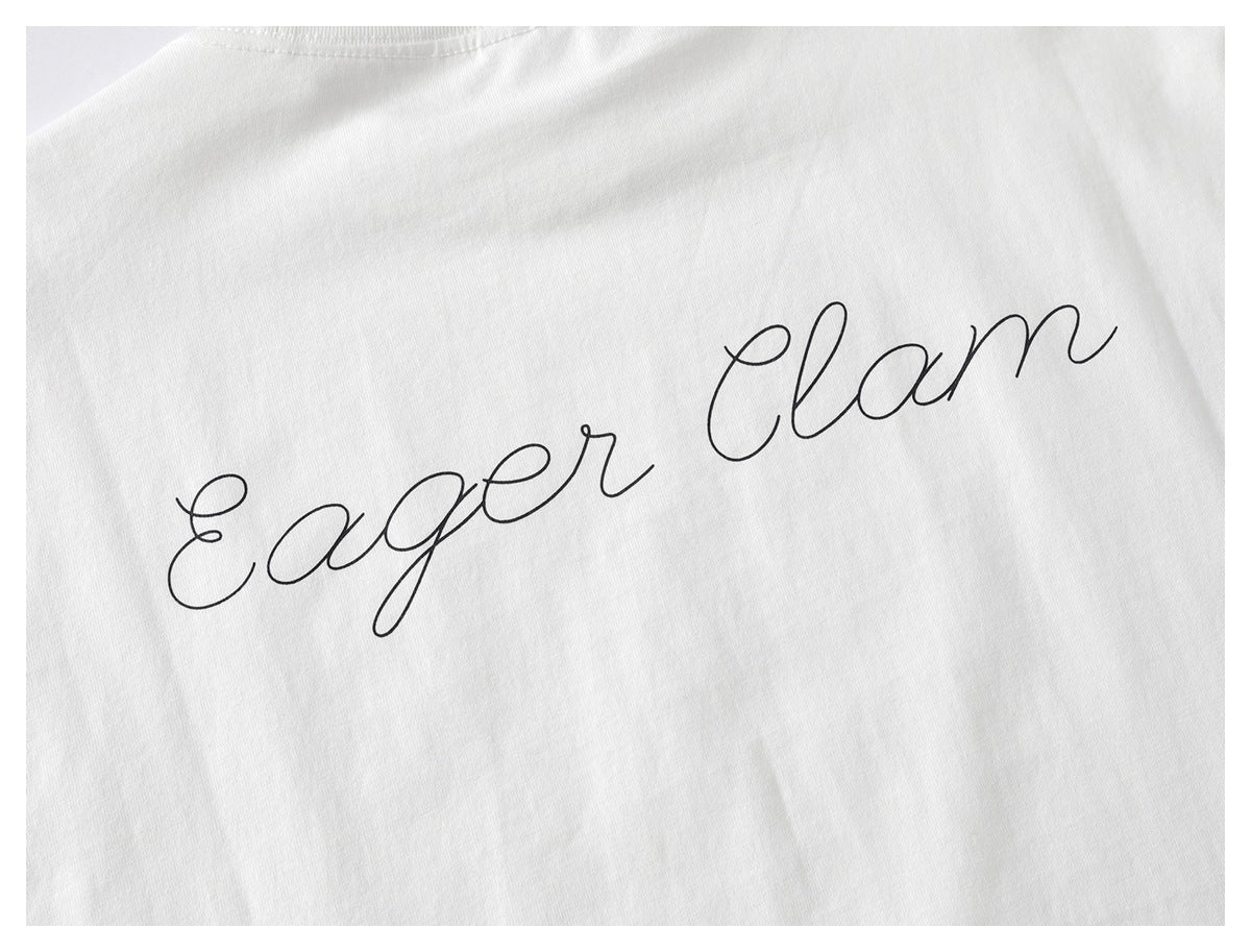 Close-up of a white shirt with large black cursive “Eager Clam” lettering.