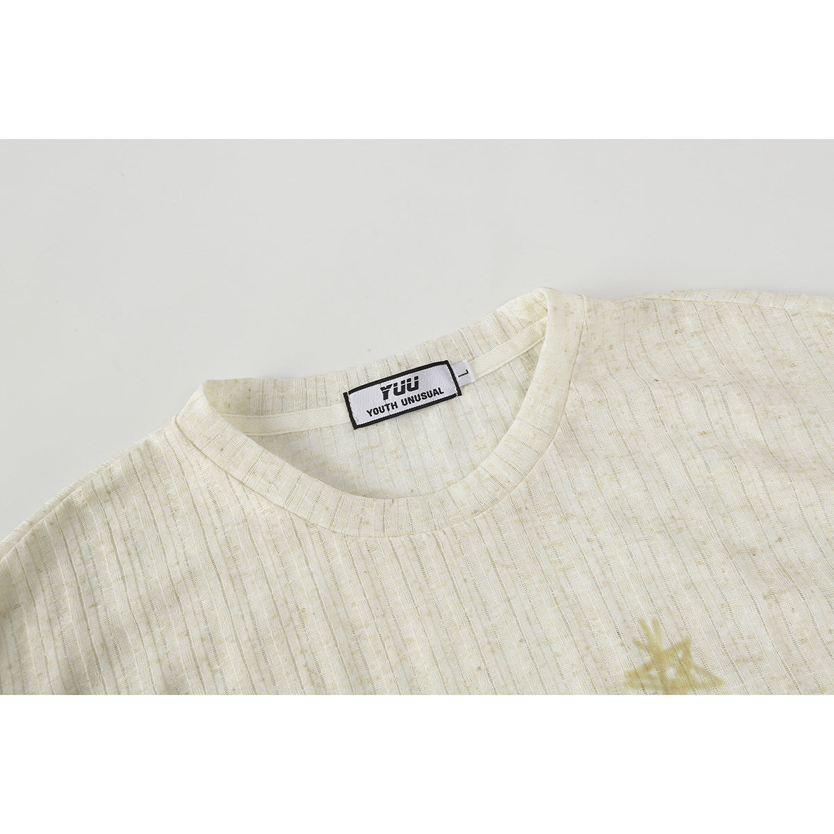 Close-up of an ivory ribbed crew-neck shirt showing the collar and sewn-in neck label.