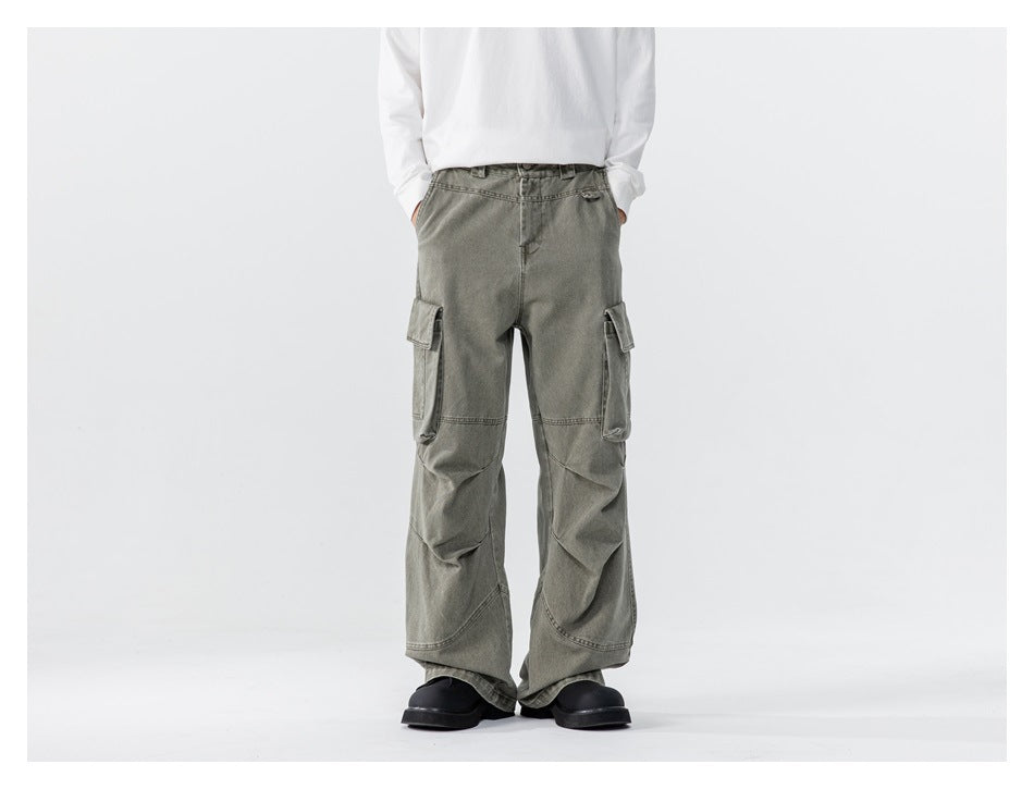 Model wearing green washed wide-leg cargo pants with a white long-sleeve top and black chunky shoes, front view