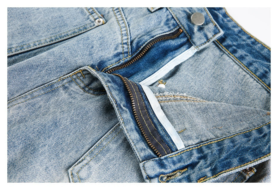 Close-up of light blue jeans with the waistband unbuttoned and zipper fly open.