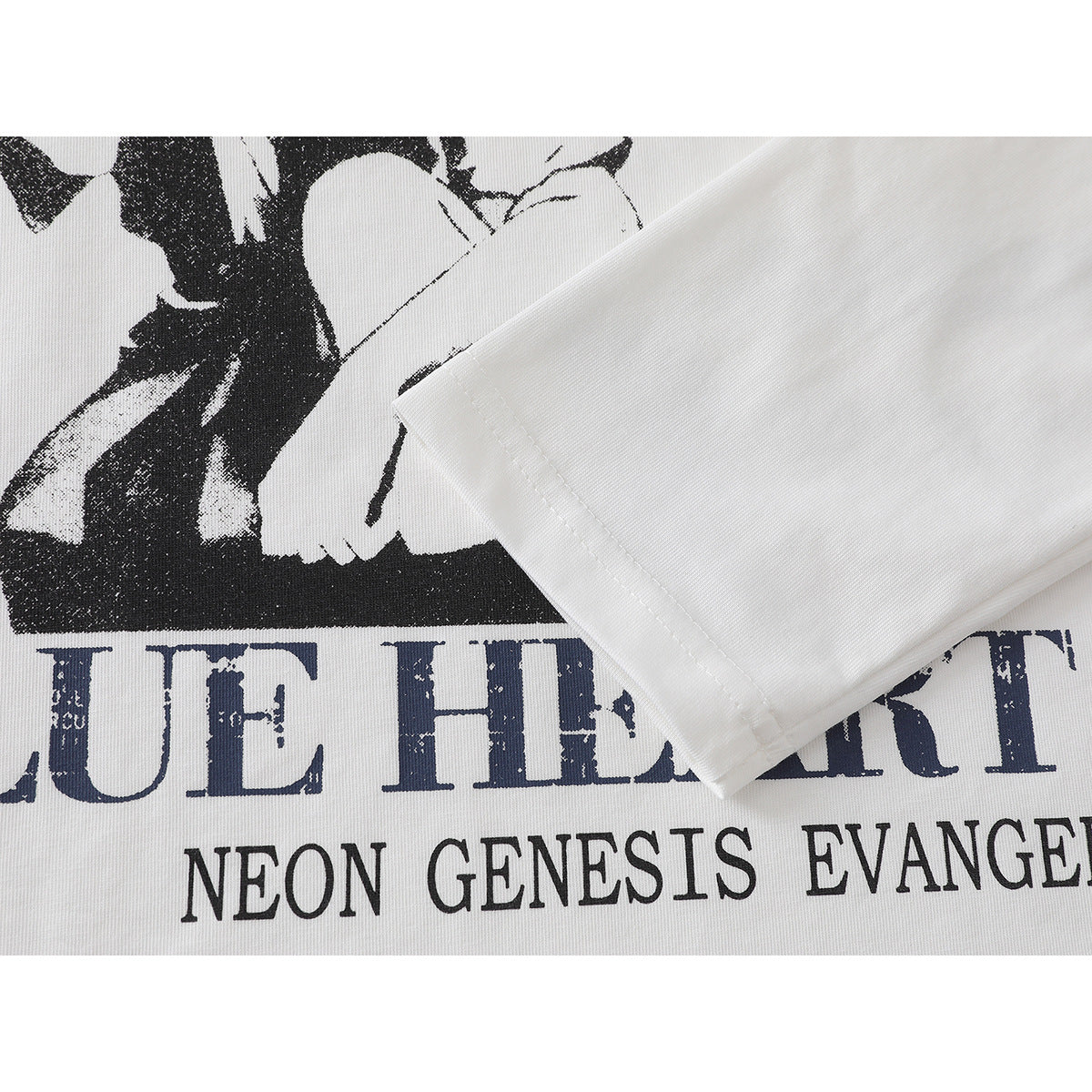 Close-up of a white T-shirt sleeve overlapping part of its black and navy front graphic.