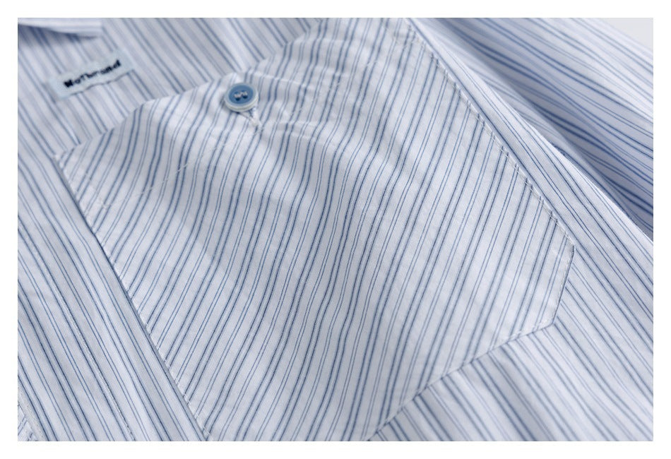 Close-up of the blue-striped shirt pocket, button, and stitching.