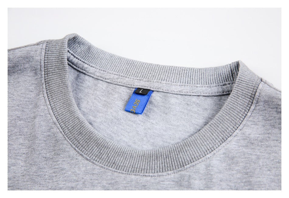 Close-up of the ribbed crew neck and blue size label on a heather gray top.
