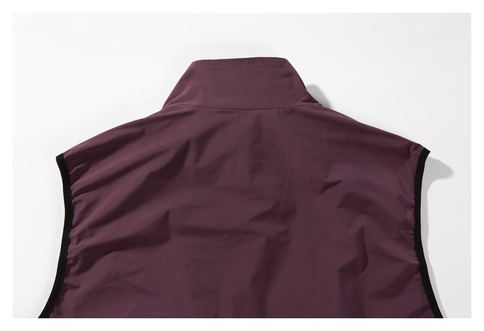 Close-up of the back of a plum sleeveless vest, showing its raised collar and black-trimmed armholes.