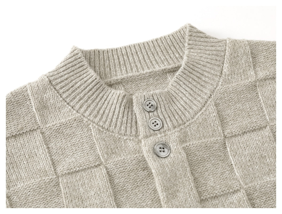 Close-up of a light beige knit cardigan’s ribbed round neckline and three-button placket.
