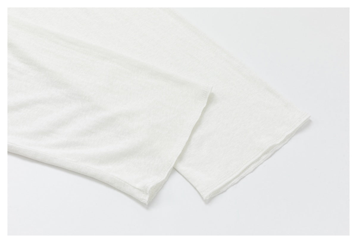 Close-up of plain white fabric showing overlapping finished edges against a white background.
