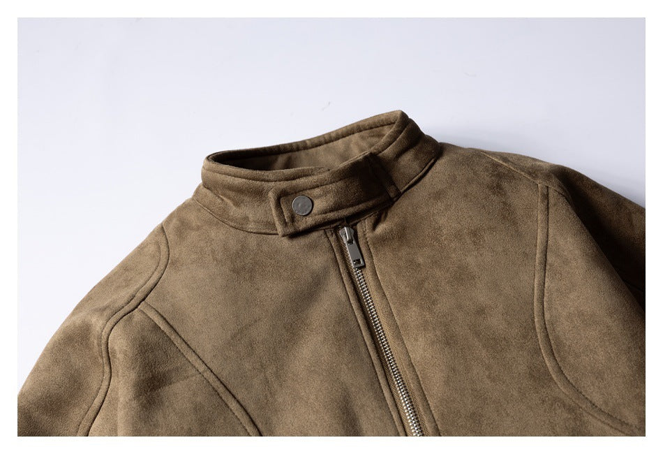 Close-up of a taupe-brown jacket front showing its snap-tab stand collar, metal zipper, and curved seams.