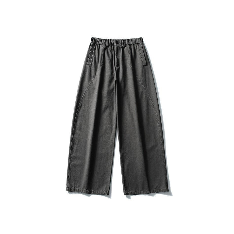 Dark gray wide-leg pants laid flat, front view, with elastic waistband, button closure, side pockets and curved seams