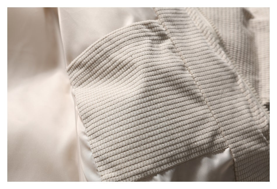 Close-up of the jacket's textured sleeve panel beside its smooth light-colored lining.