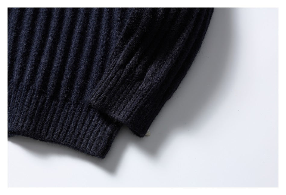 Close-up of the dark navy cardigan's ribbed sleeve and cuff.
