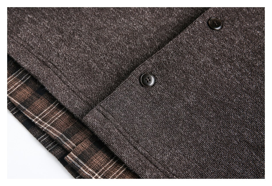 Close-up of two dark buttons on the textured brown jacket, with plaid fabric visible underneath.