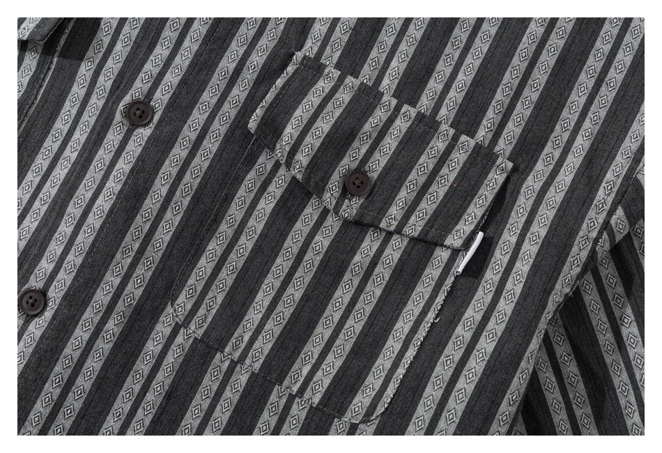 Close-up of the striped shirt front, showing its button placket and chest pocket.