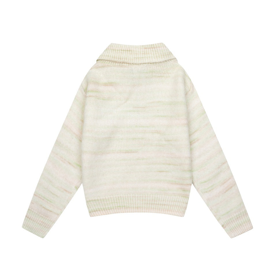 Back view of an ivory knit sweater with a folded collar, long sleeves, ribbed hems, and faint pastel horizontal streaks.