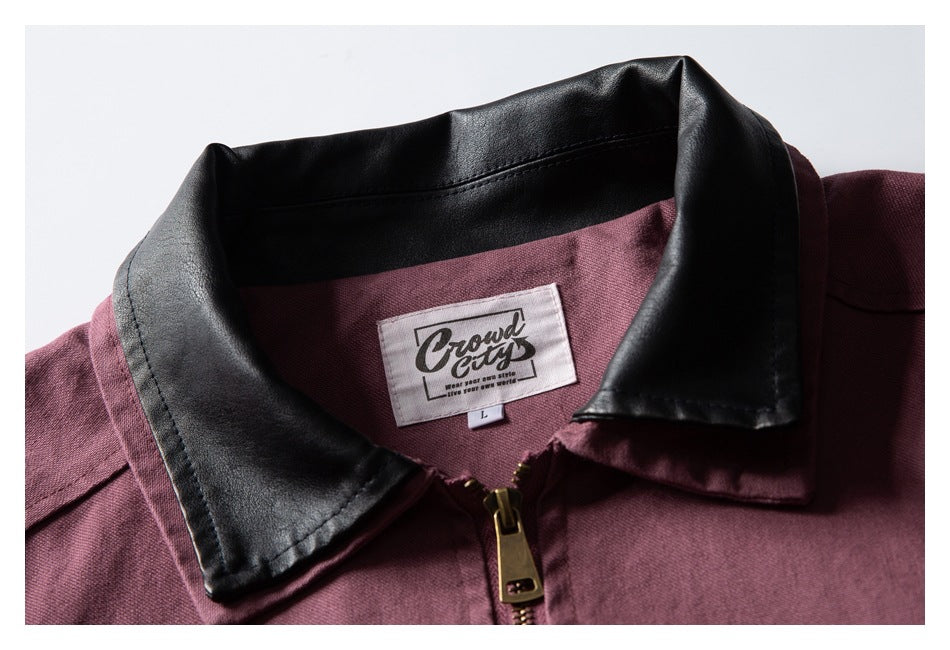 Close-up of a burgundy jacket collar, black collar facing, front zipper, and visible neck label.
