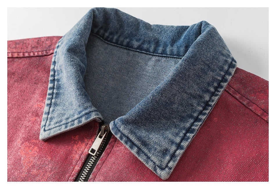 Close-up of the jacket's contrasting blue denim collar, red distressed fabric and metal zipper.