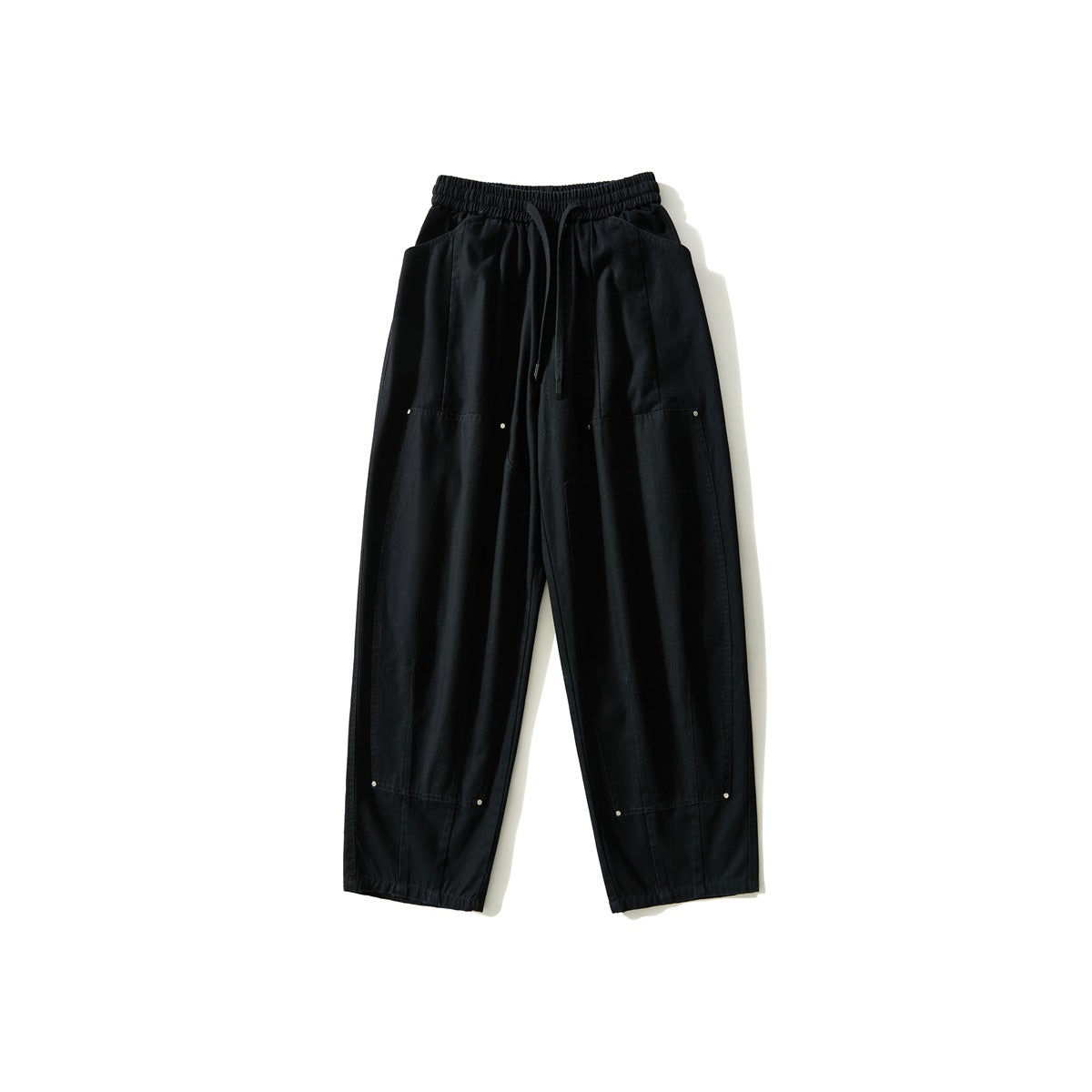 Black wide-leg pants front view with drawstring elastic waist, large front pockets and metal rivet accents