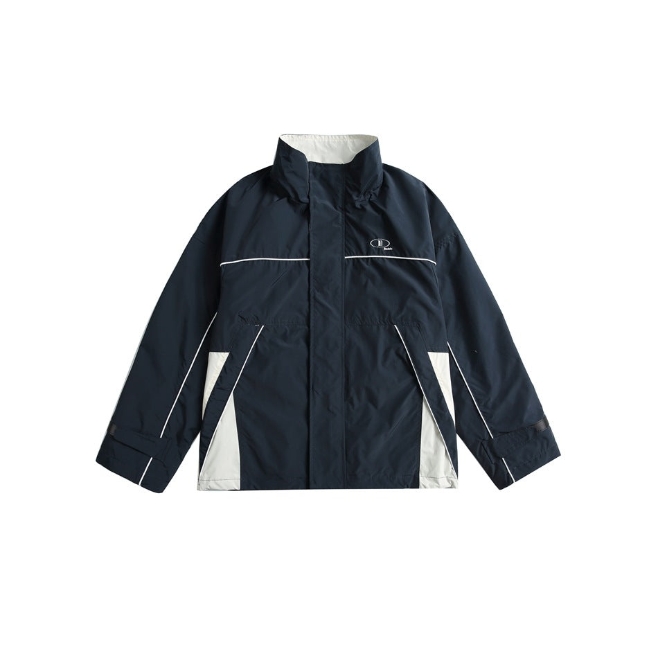 Navy stand-collar zip jacket with white piping and off-white side panels, flat lay front view