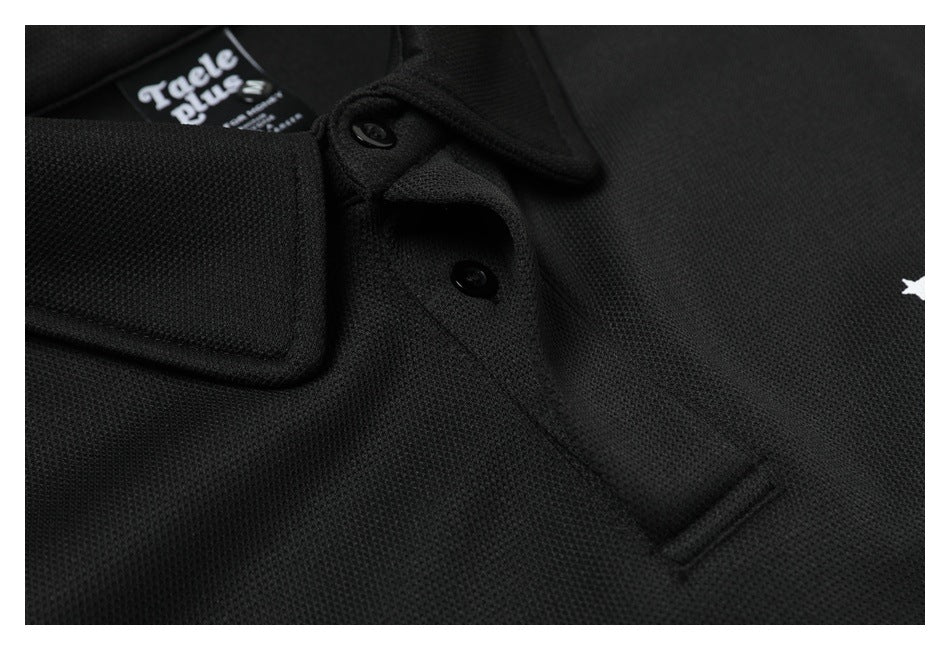 Close-up of a black polo collar and button placket with two black buttons and a partially visible neck label.