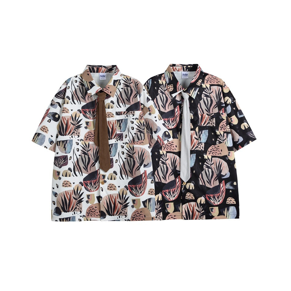 Two short-sleeve shirts with the same abstract botanical print shown in white and dark colorways.