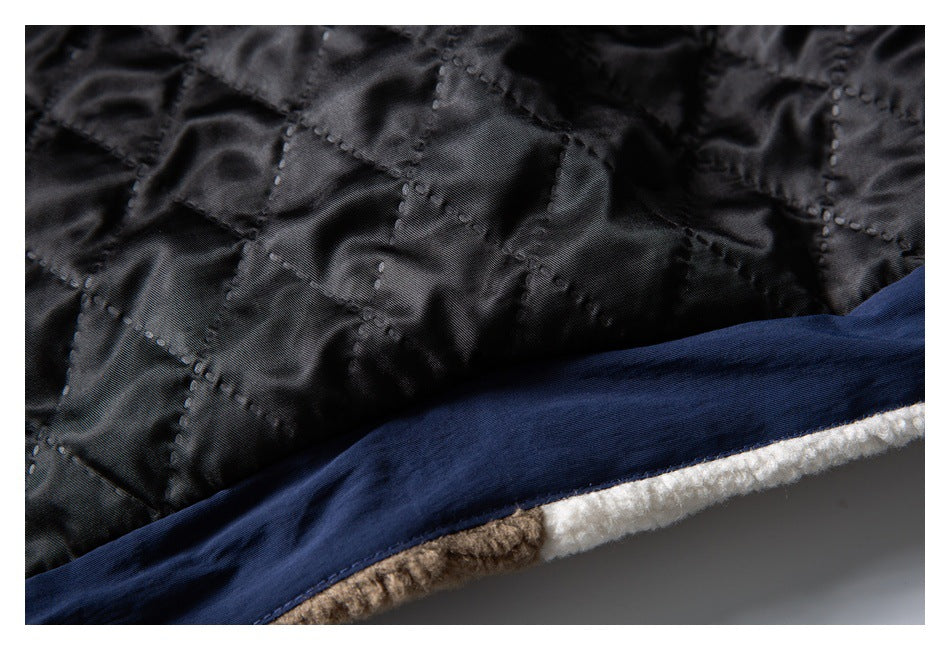 Close-up of black quilted lining beside navy binding and a white fleece edge.