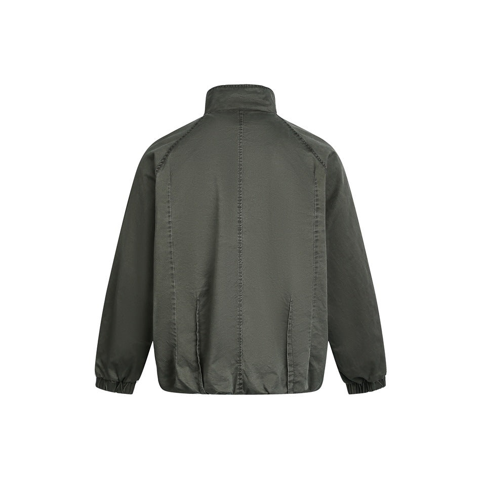 Back view of a dark olive jacket with a stand collar, raglan sleeves, seam detailing, and elastic cuffs.