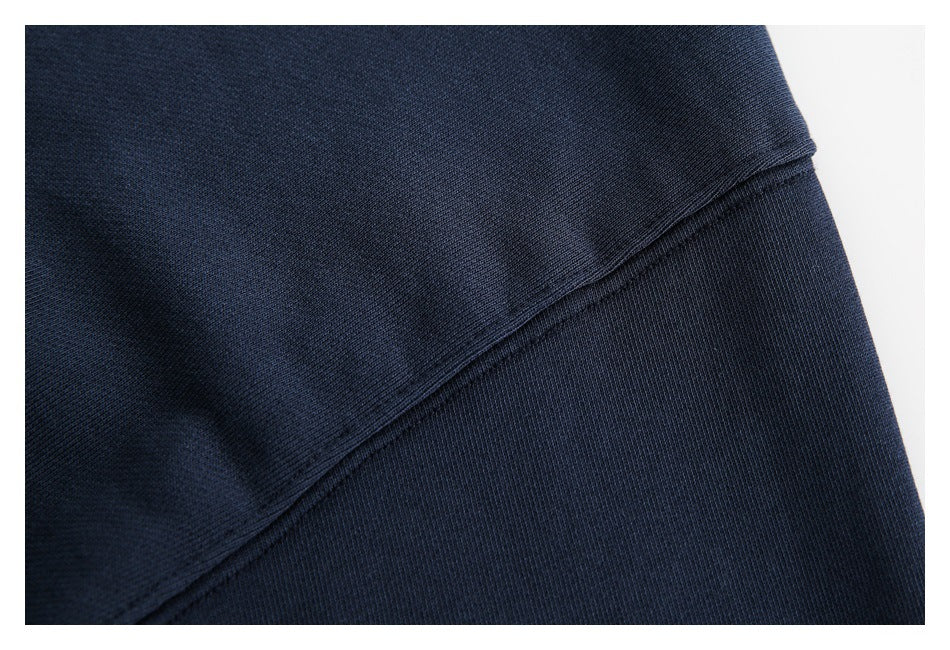 Close-up of a diagonal stitched seam on dark navy fabric.
