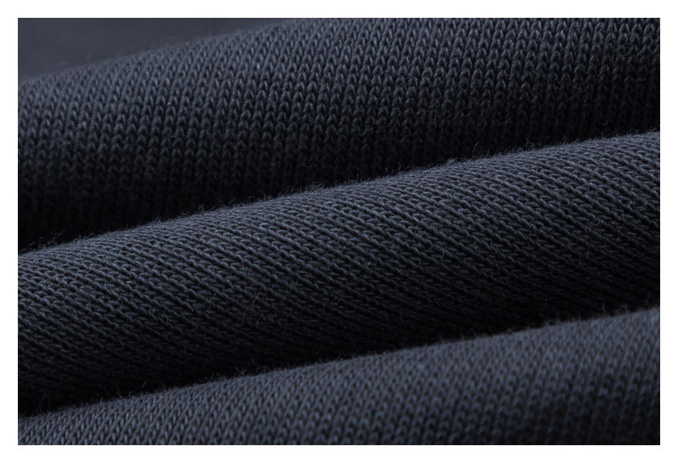 Macro view of the dark knit fabric texture of the pants.