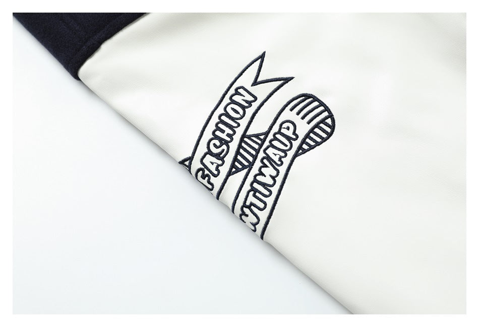 Close-up of dark embroidered banner-style lettering on a white sleeve panel.