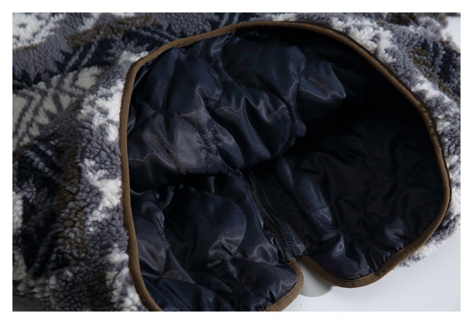 Close-up of a garment opening with dark quilted lining and brown edging.