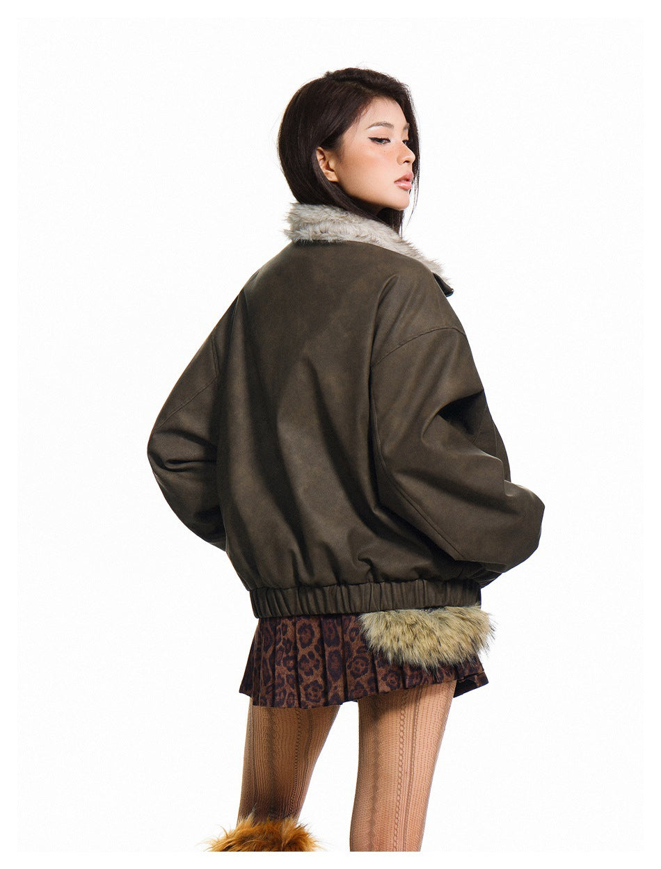 Rear view of a model wearing a dark brown jacket with a pale fuzzy collar and elasticated hem.