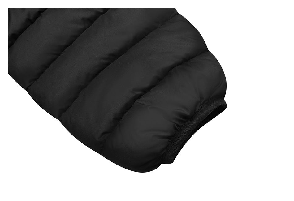 Close-up of a black quilted jacket sleeve and its narrow elastic cuff.