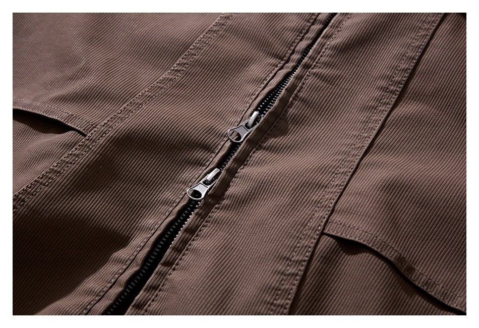Close-up of the brown jacket's two-way front zipper and stitched ribbed panels.