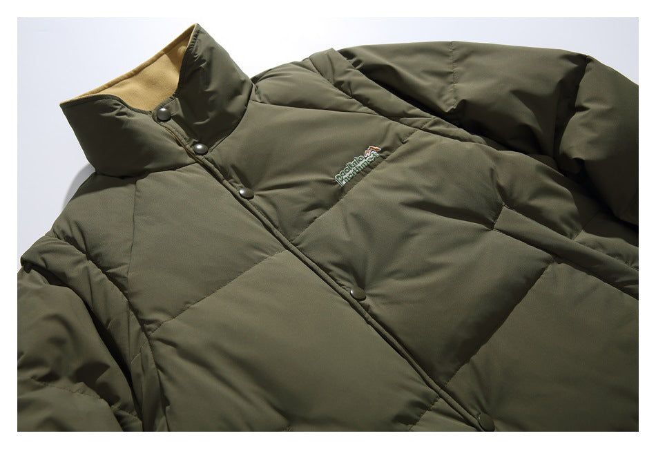 Olive quilted puffer jacket laid flat, showing its high collar, snap-button front, and small embroidered chest logo.