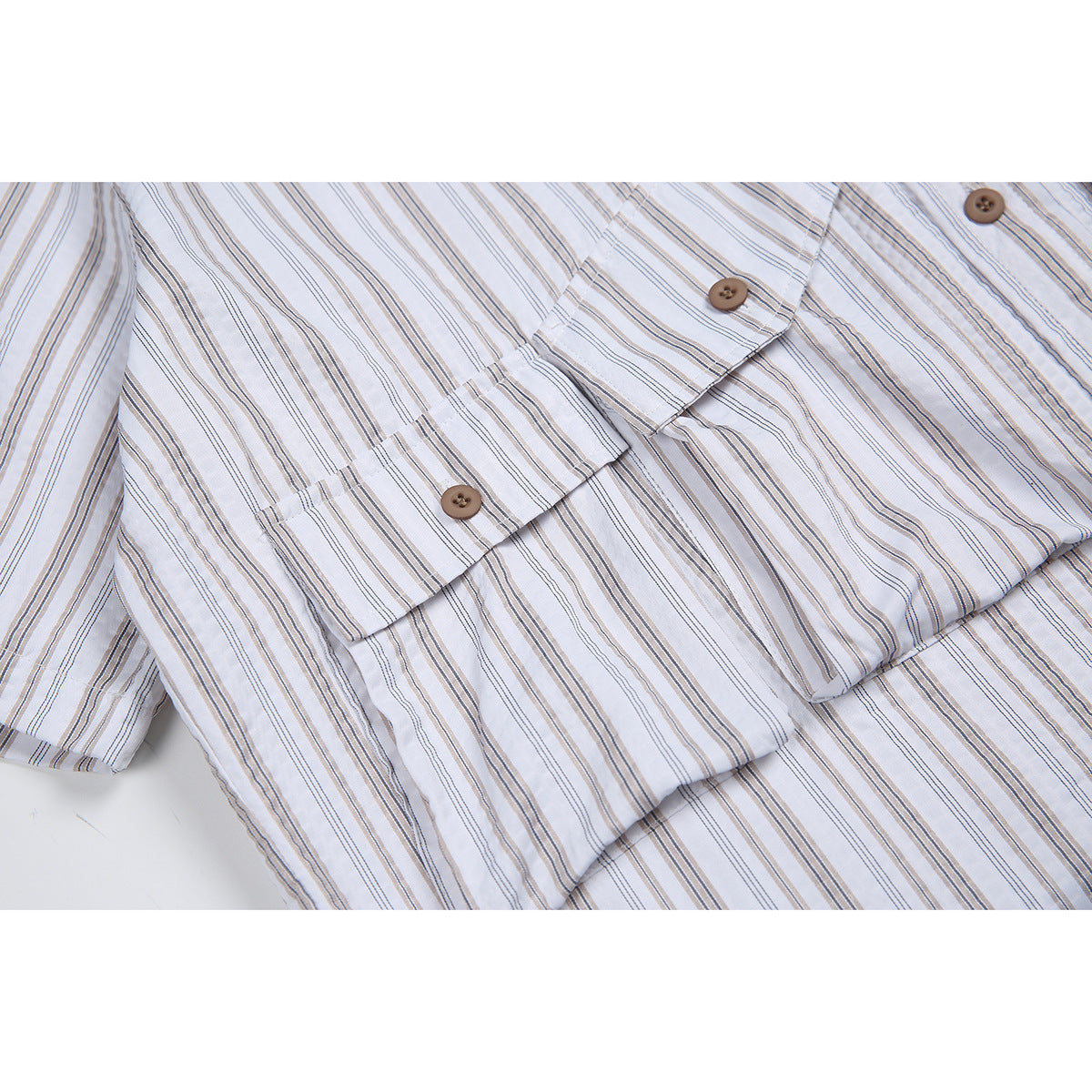 Close-up of the striped shirt's front placket, brown buttons, and short sleeve.