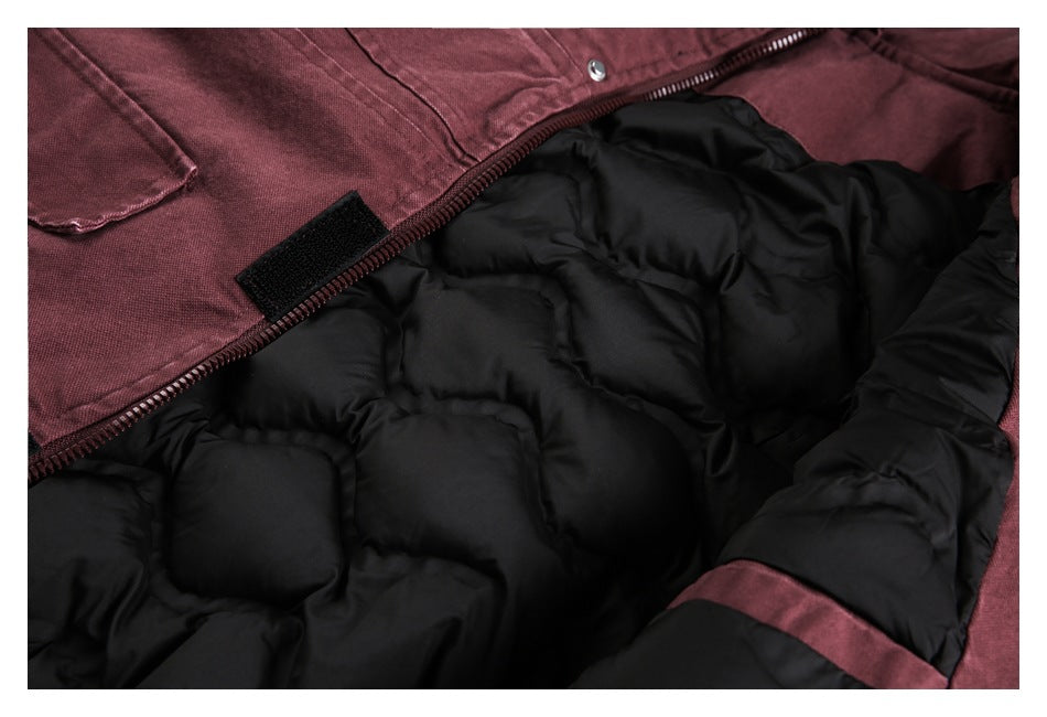 Burgundy jacket opened to show its black quilted lining, zipper, and inner fastening tab.