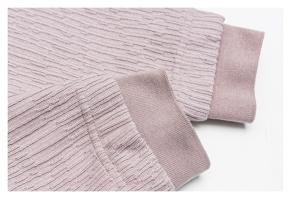 Close-up of a mauve knit top's textured sleeve and solid ribbed cuff.