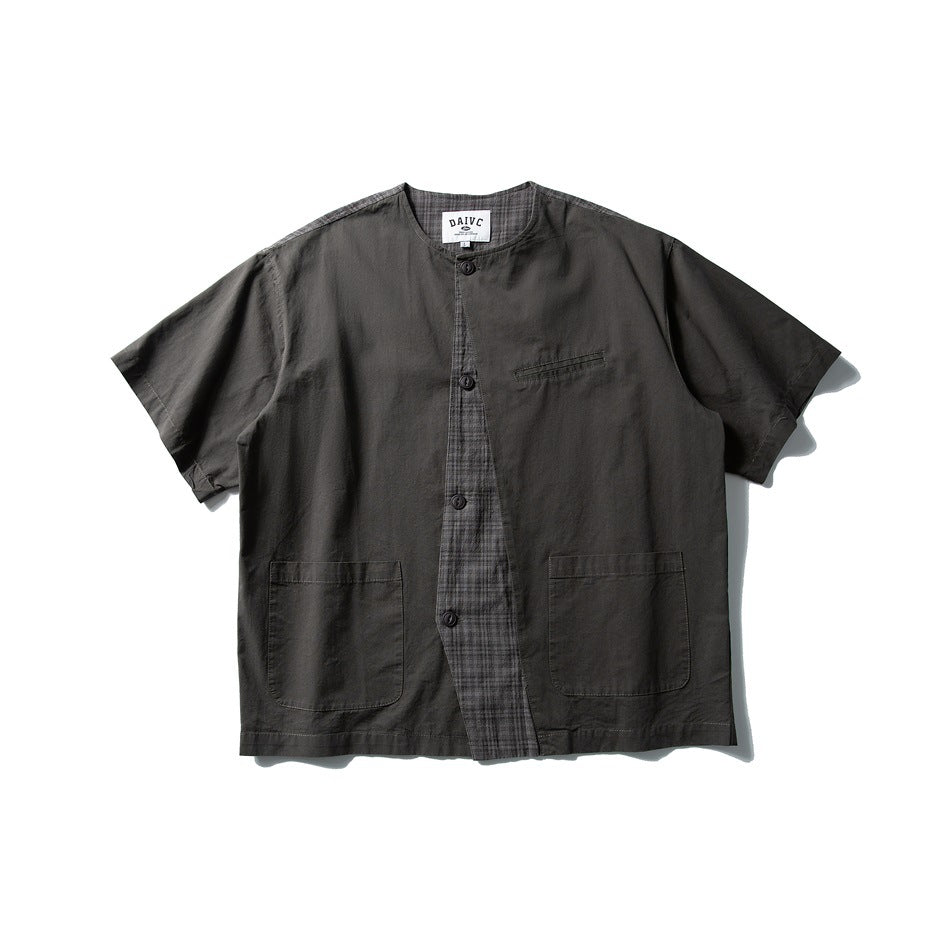 Dark gray short-sleeve collarless button-front shirt with plaid placket panel, chest welt pocket and two patch pockets, flat