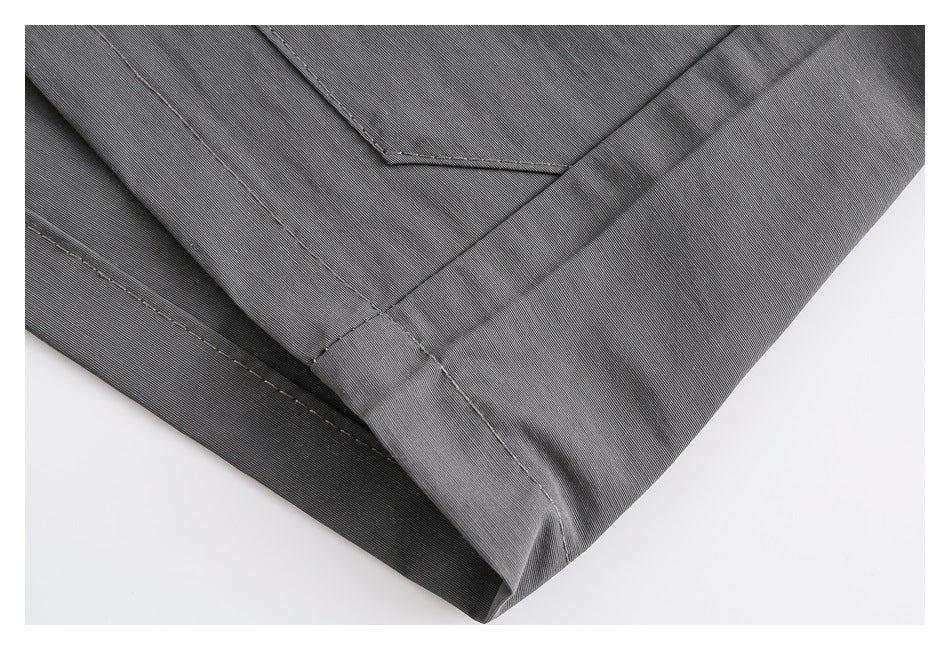 Close-up of gray bottoms showing the stitched hem and folded fabric edge.
