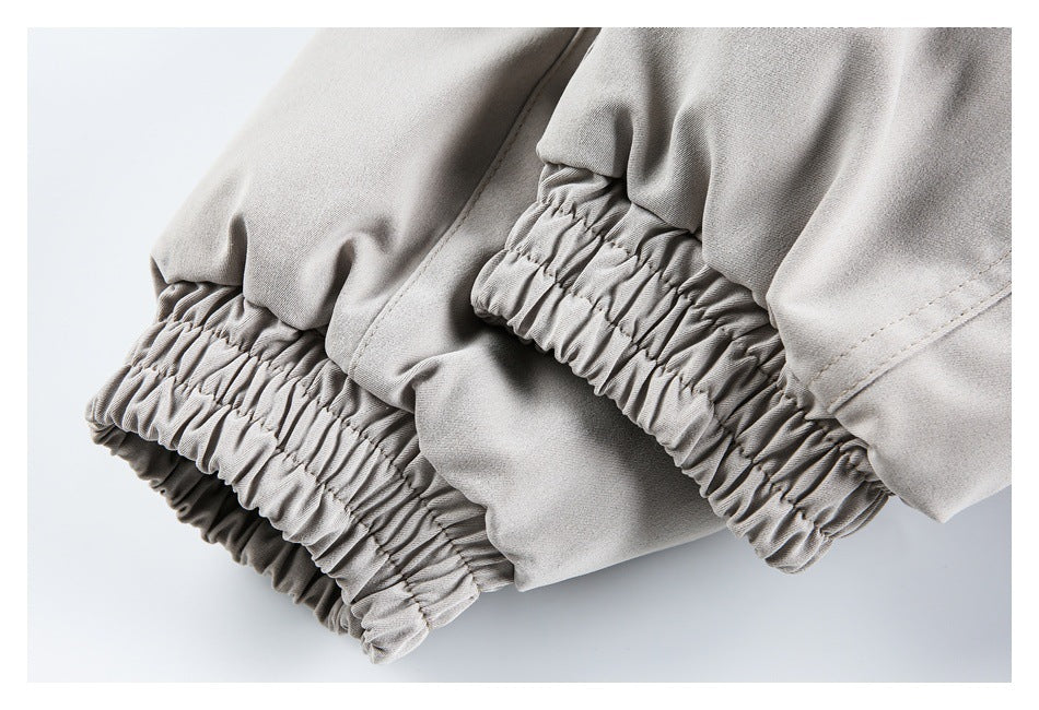 Close-up of pale gray-beige garment fabric with a gathered elastic cuff or hem.