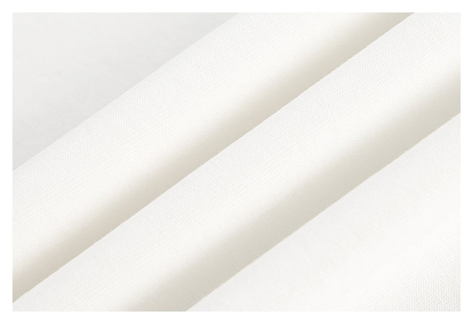 Extreme close-up of white fabric folded into diagonal ridges.