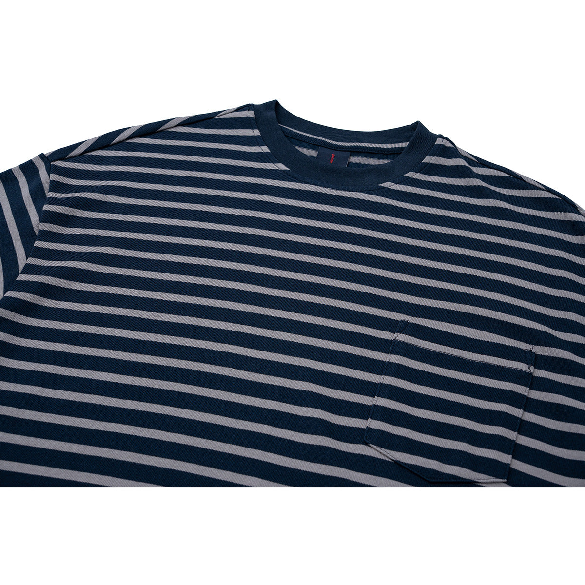 Close-up of a navy crew-neck T-shirt with thin gray horizontal stripes and a chest pocket.