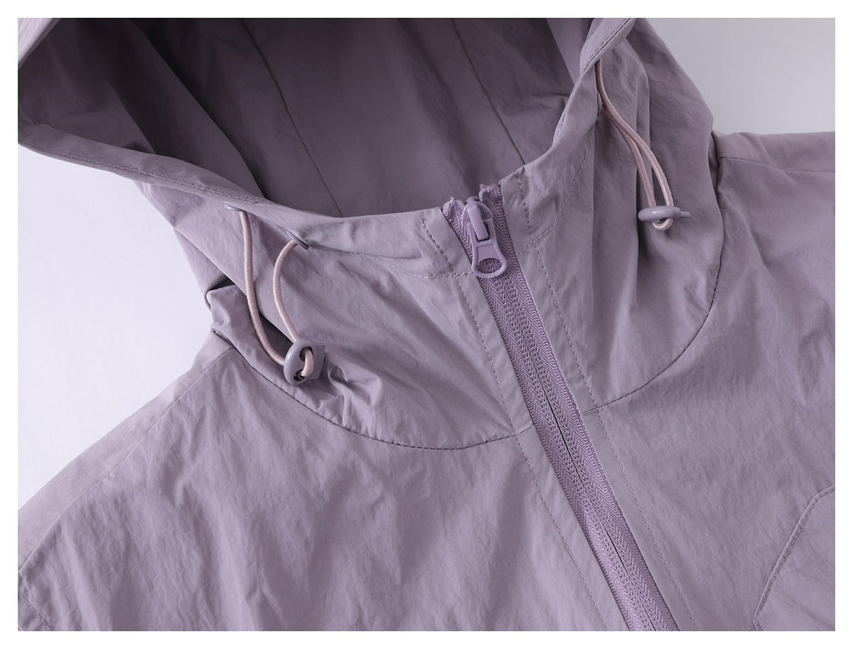 Close-up of the lavender hood opening, drawcord toggles, and zipper on the jacket.