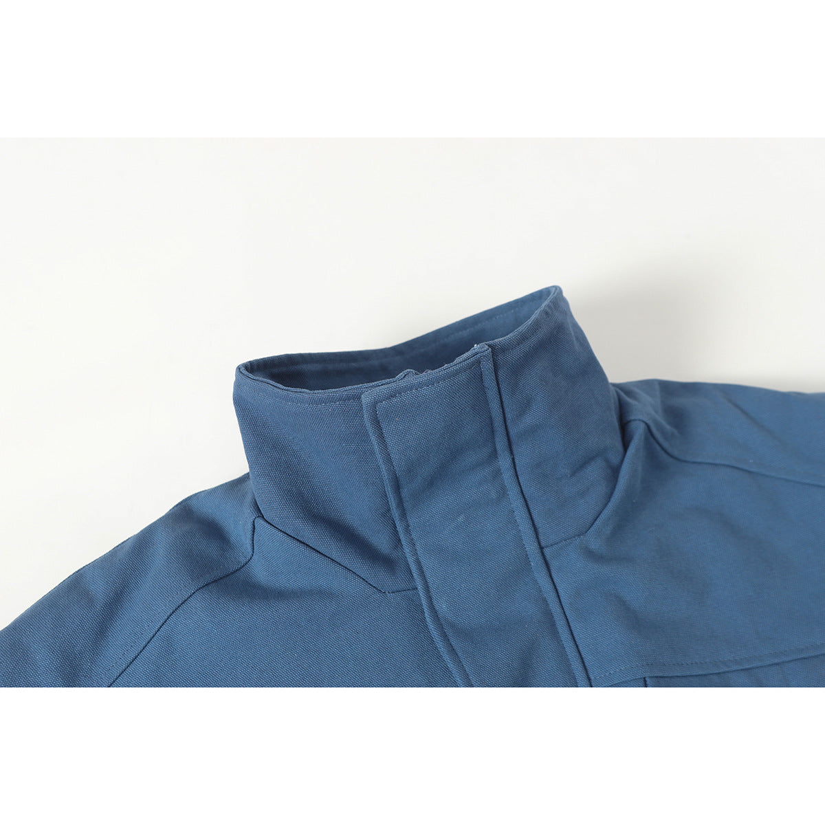 Close-up of a blue jacket's tall stand collar and covered front placket.