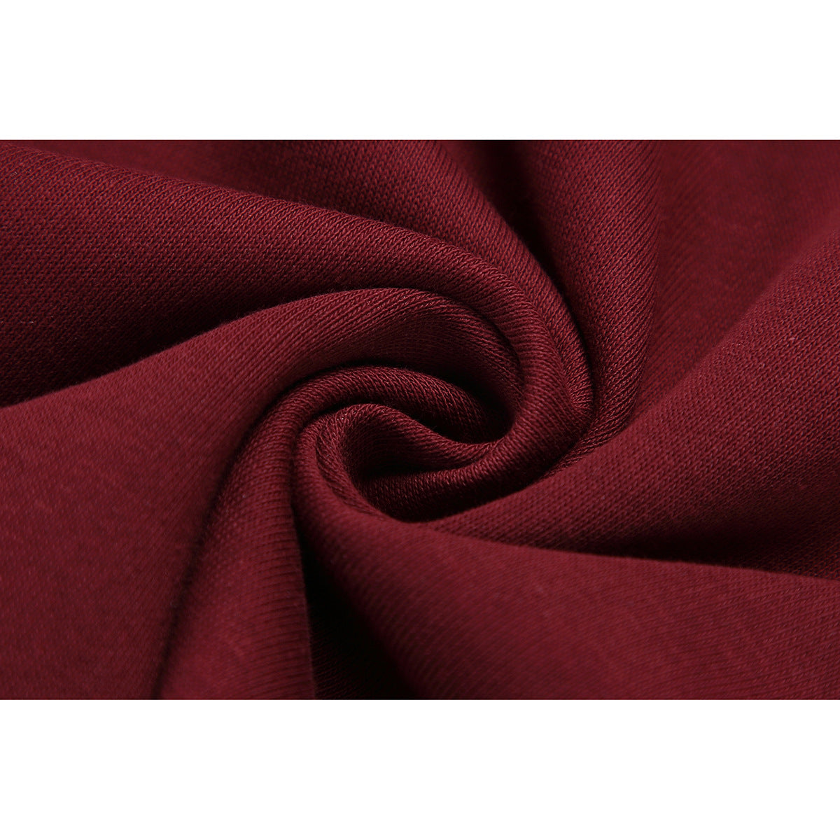 Close-up of burgundy fabric gathered into folds, showing its textured surface.