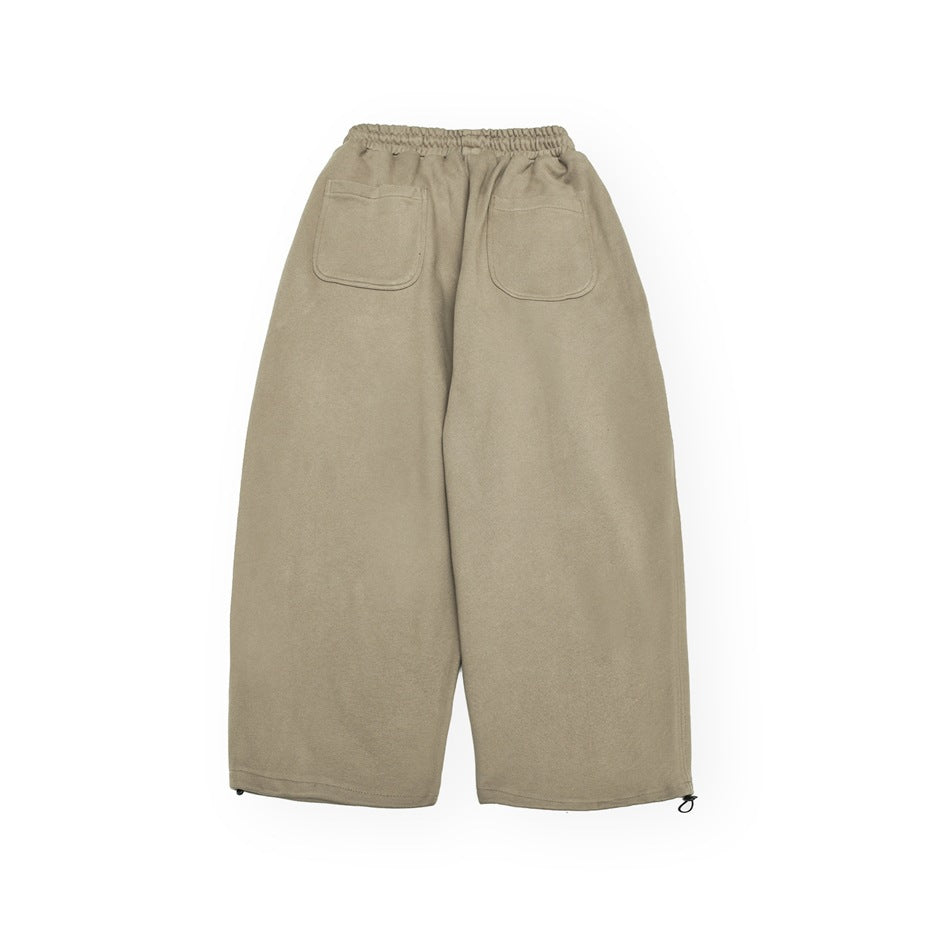 Full back view of taupe wide-leg pants with an elastic waist and two patch pockets.